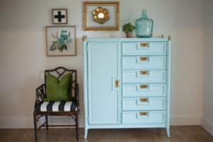 Glossy faux bamboo Stanley armoire with brass campaign hardware.