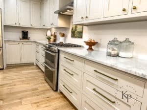 All drawer base cabinets. Kitchen cabinets in Revere Pewter with brass pulls